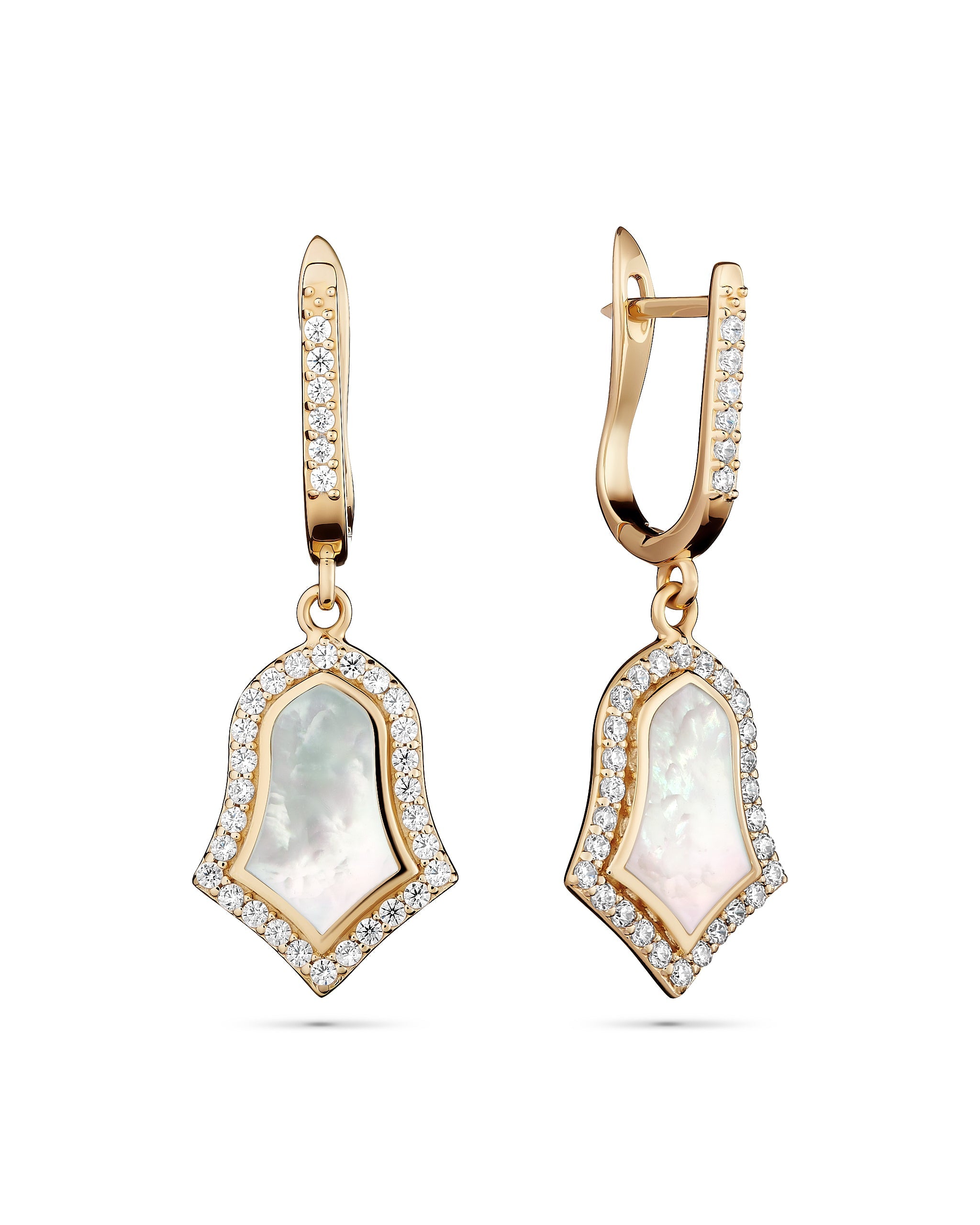 Gold earrings with clear gemstones on a white background