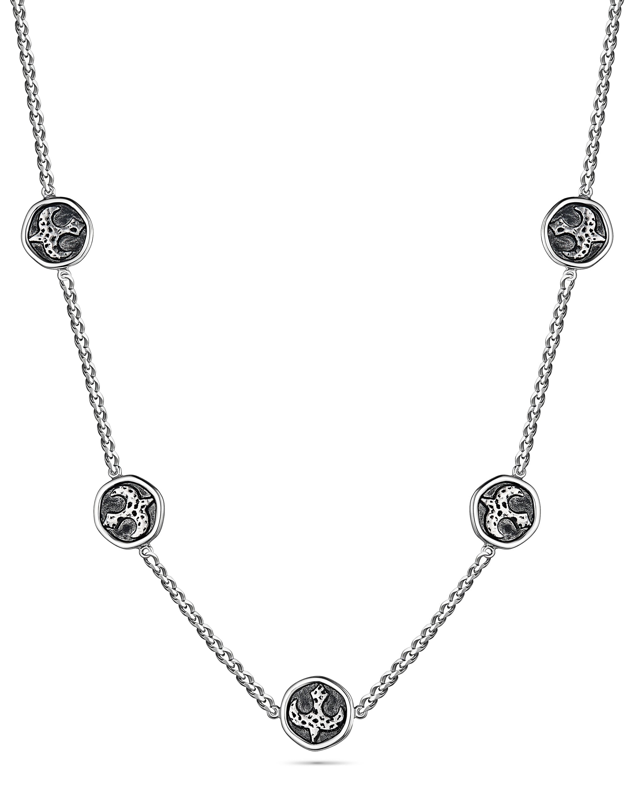 Silver necklace with circular pendants on a white background