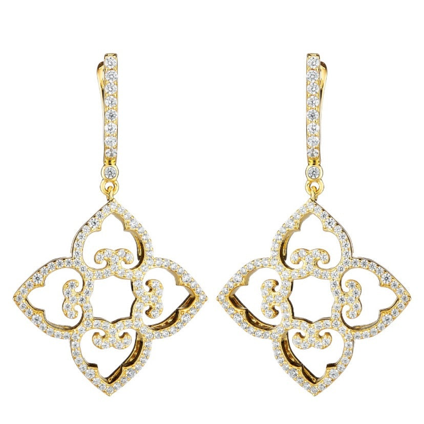 Gold and diamond earrings on a white background
