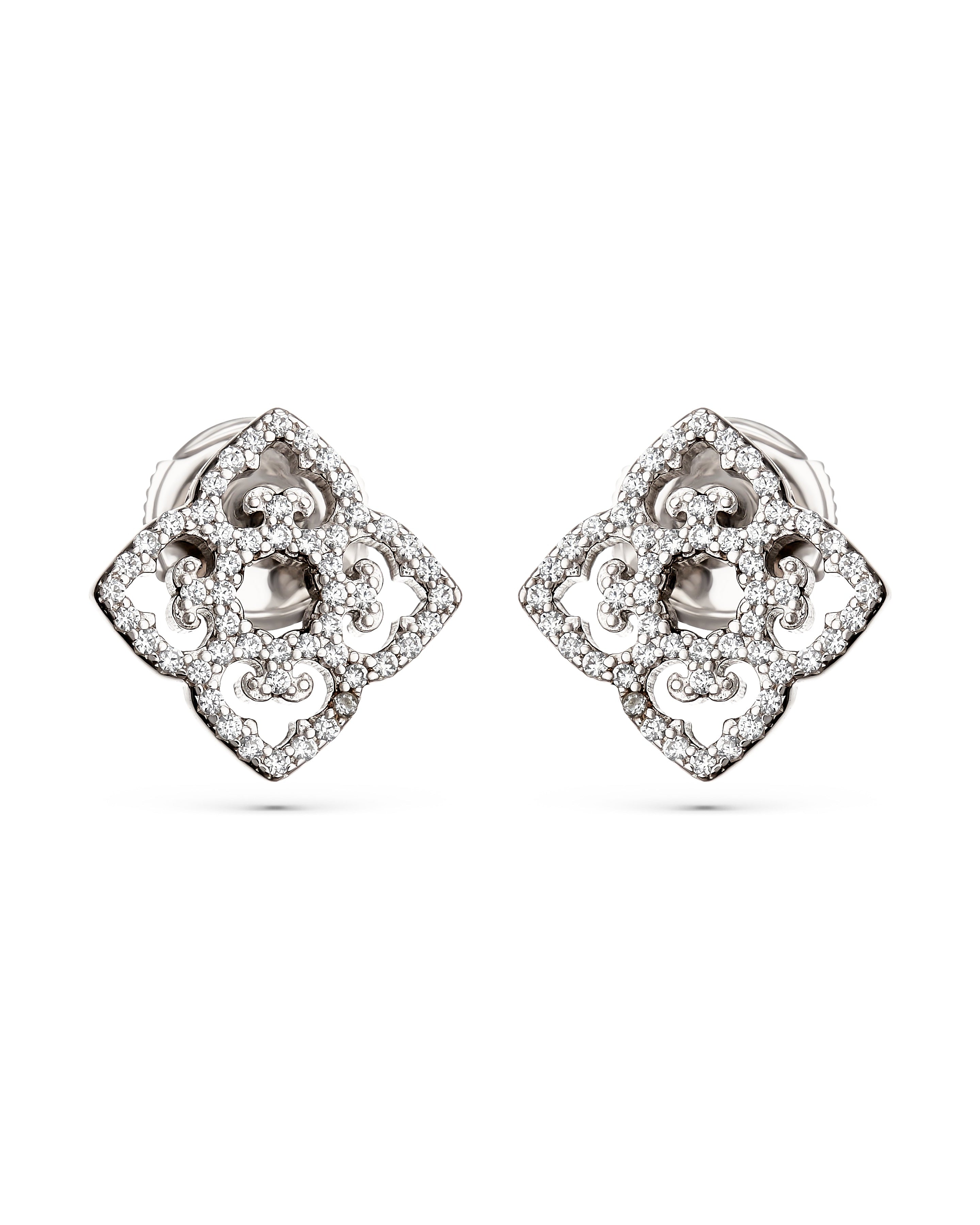 Pair of silver earrings with intricate designs on a white background