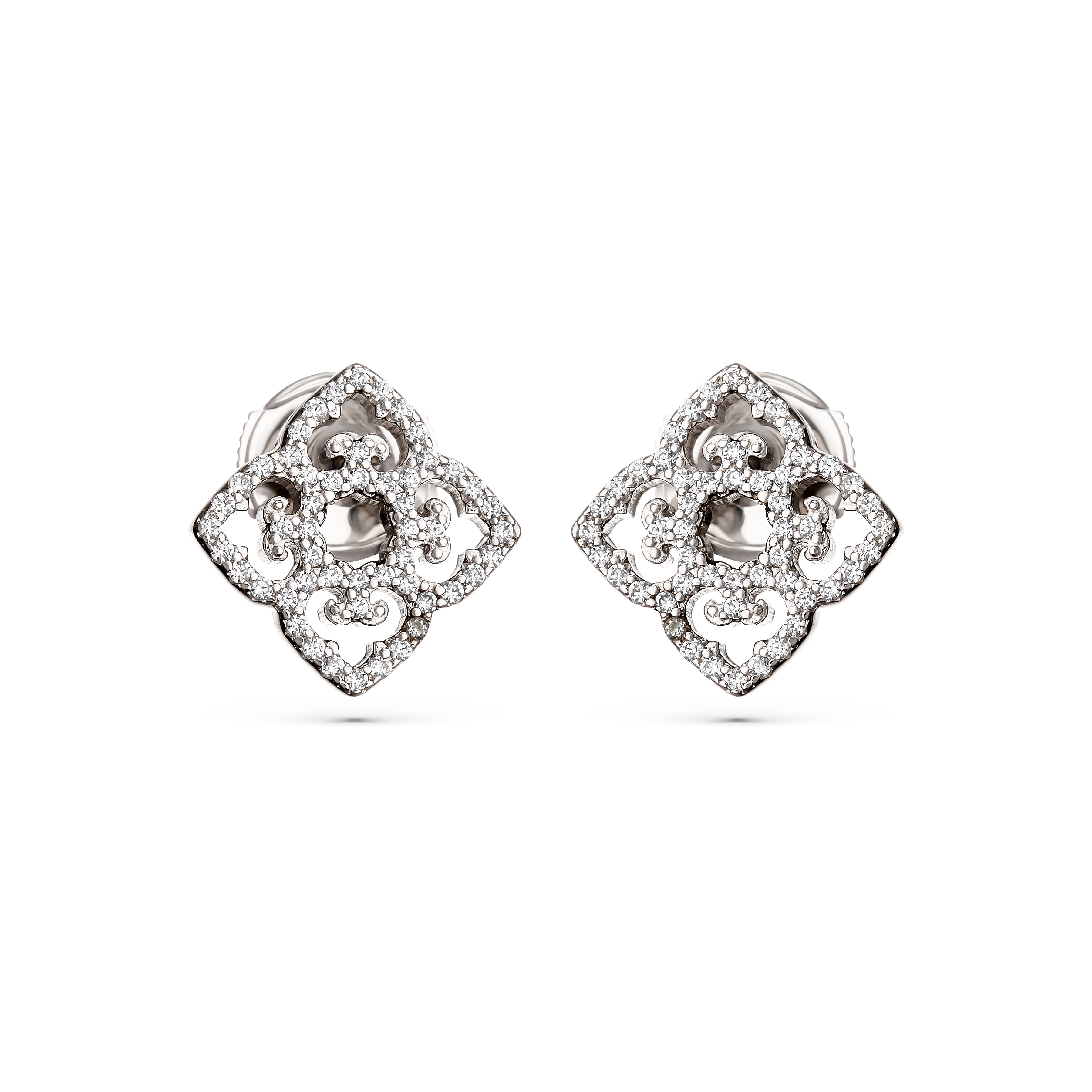 Pair of silver earrings with intricate designs on a white background