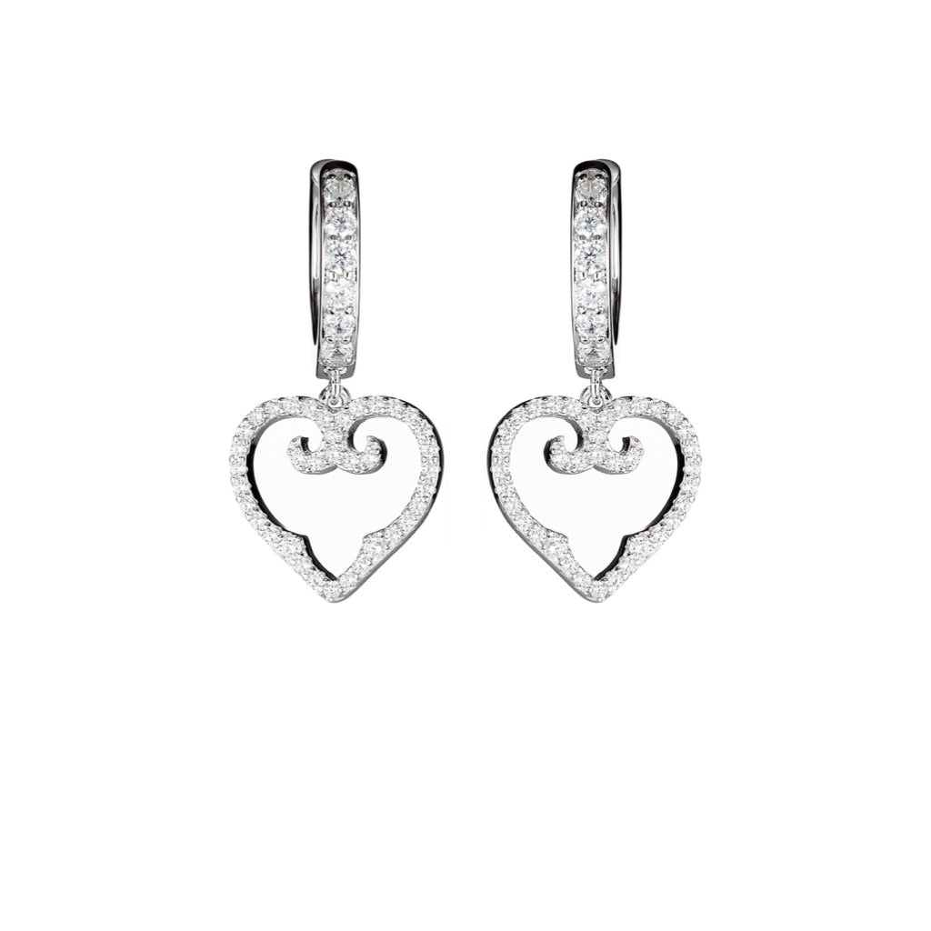 Heart-shaped earrings with diamond accents on a white background