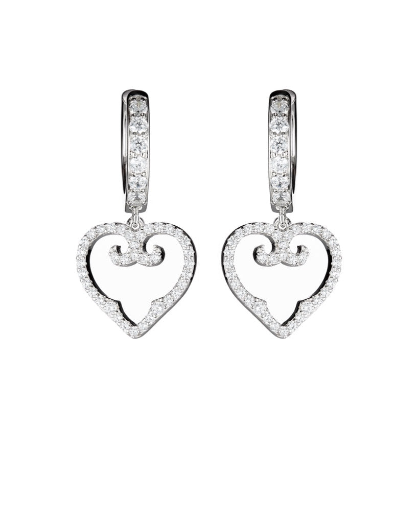 Heart-shaped earrings with diamond accents on a white background