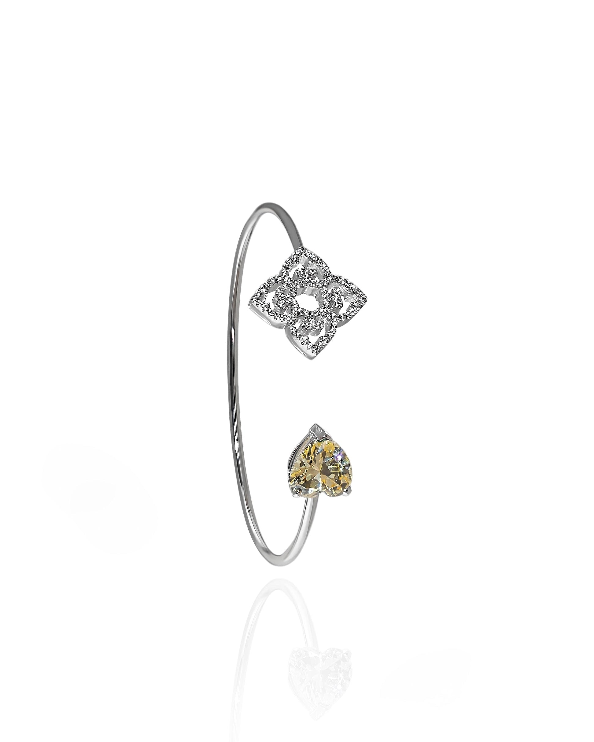Rhodium plated open bangle with yellow heart shaped stone