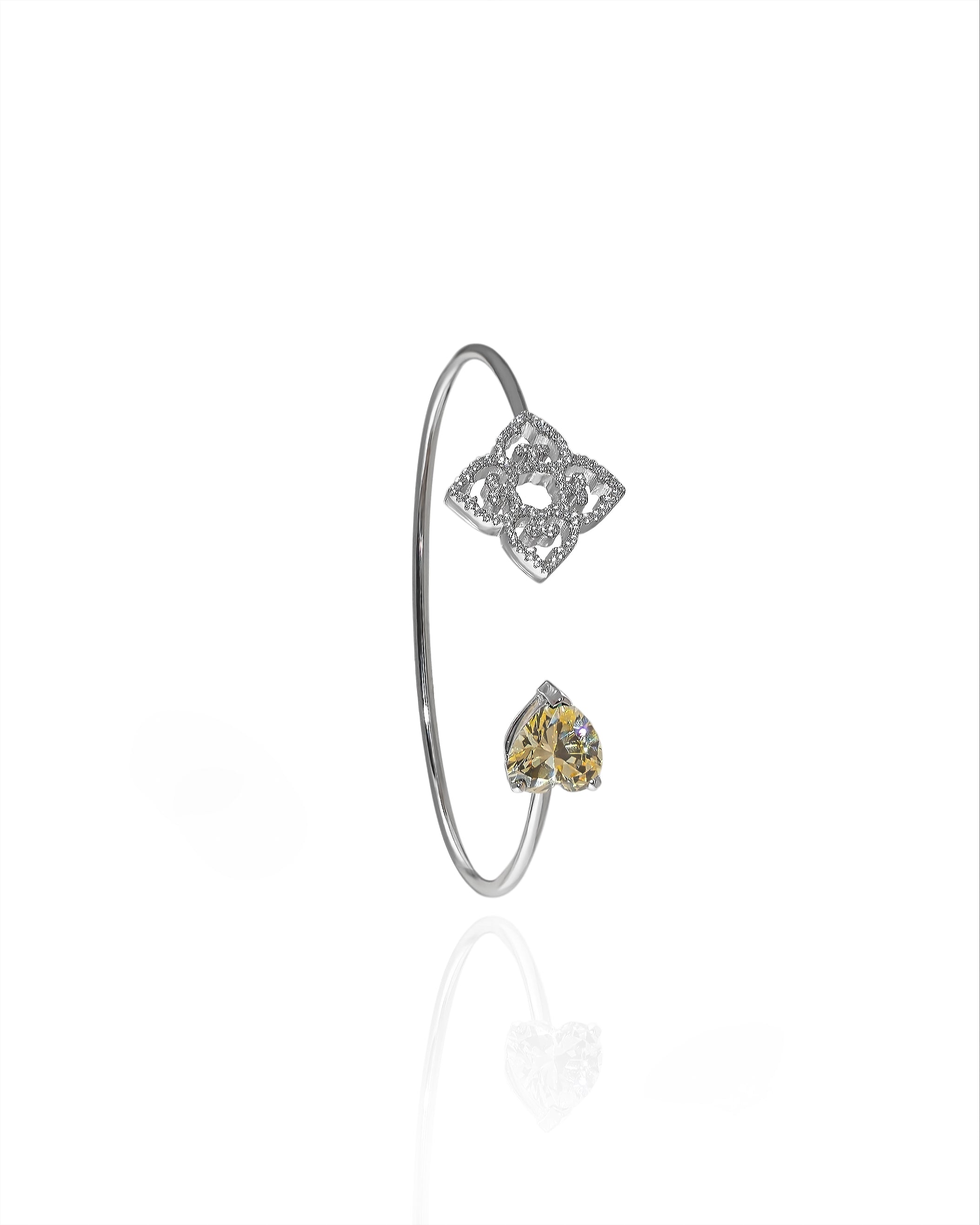 Rhodium plated open bangle with yellow heart shaped stone