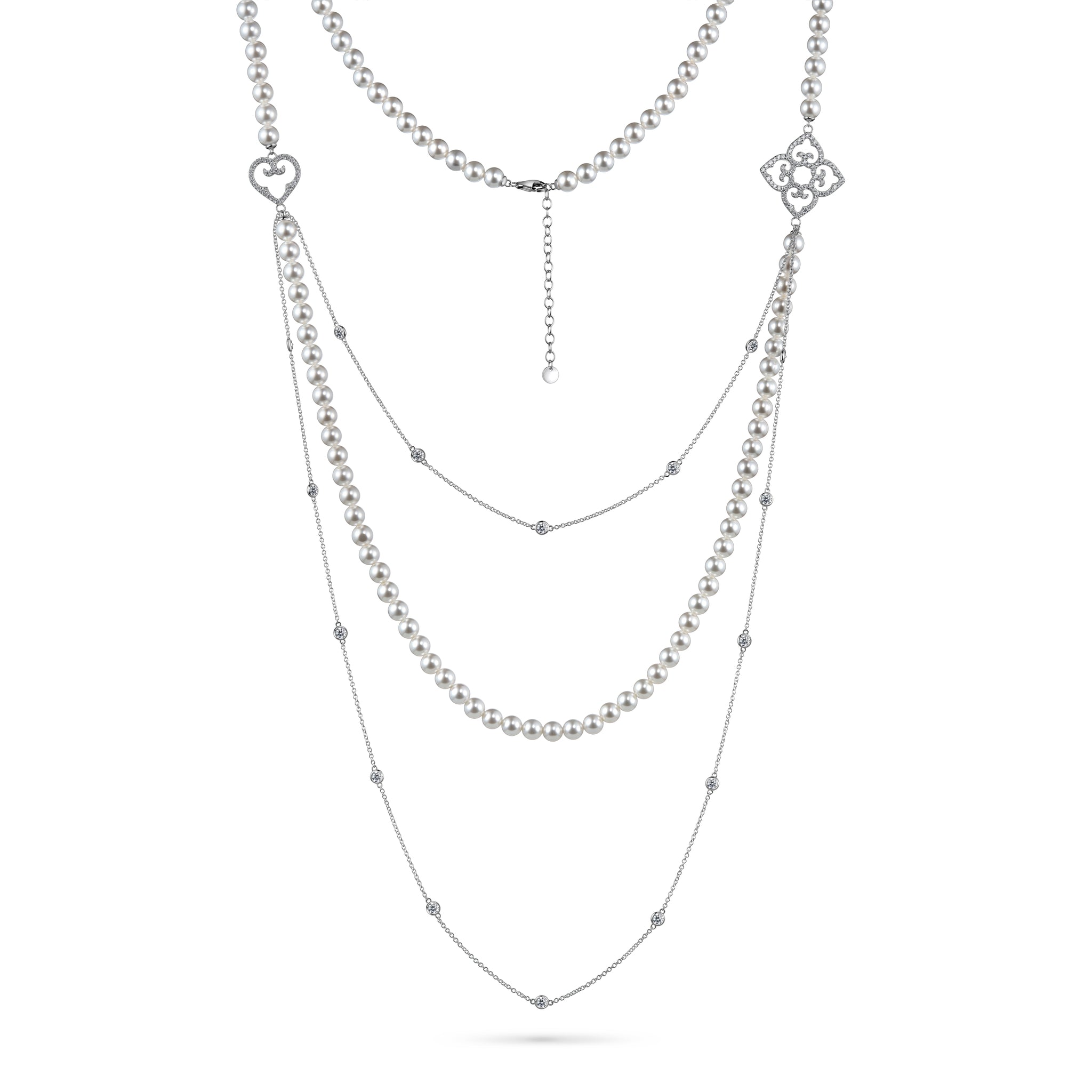 Layered silver necklace with heart and floral pendants on a white background