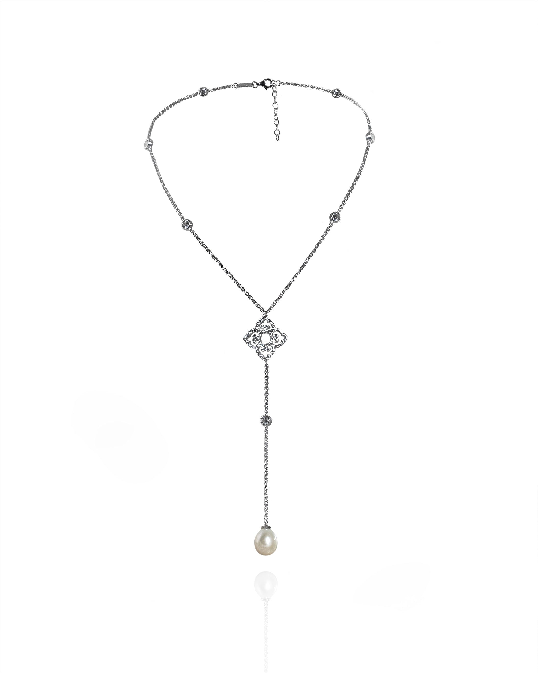 Necklace with a decorative clasp and pearl pendant on a white background