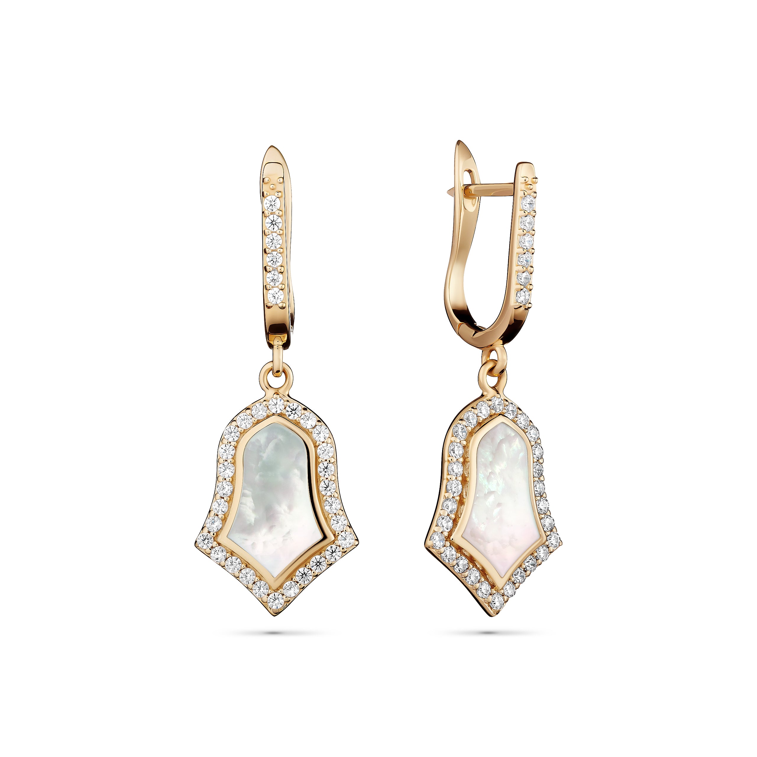 Gold earrings with clear gemstones on a white background