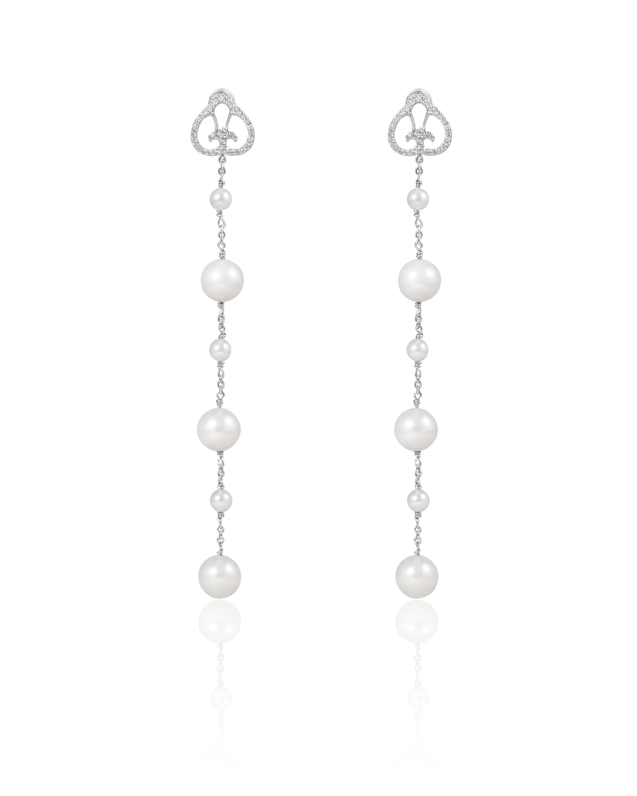Pearl drop earrings with heart-shaped connectors on a white background