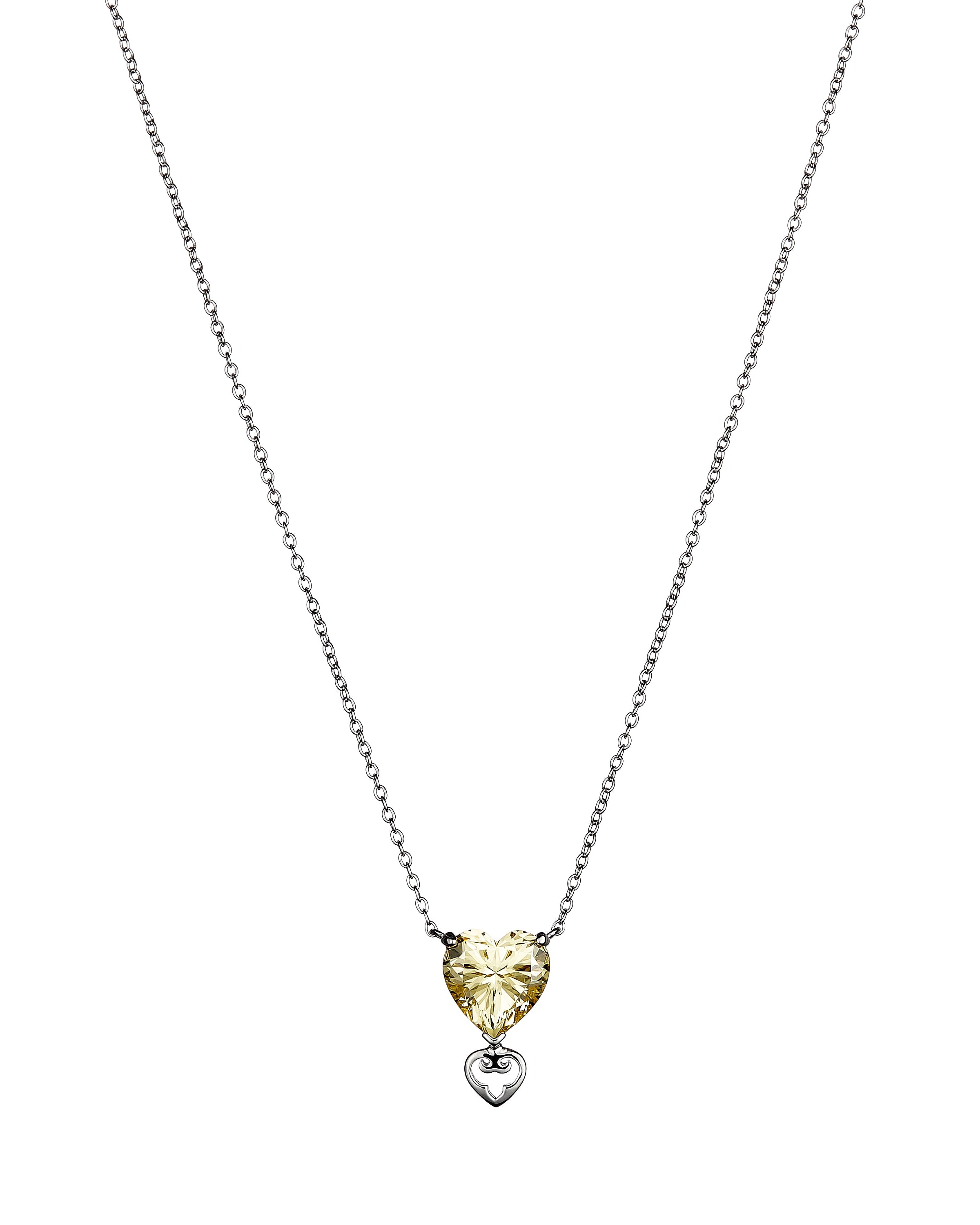 Heart-shaped pendant necklace with a yellow gemstone on a white background
